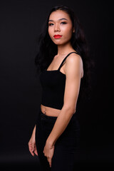 Fototapeta na wymiar Young beautiful Asian transgender woman against black background
