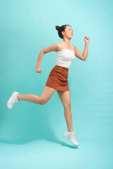 Image of emotional young lady jumping isolated over white background wall.