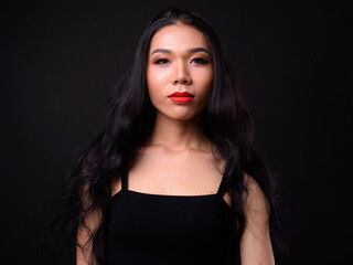 Fototapeta premium Young beautiful Asian transgender woman against black background