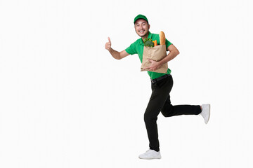 Asian delivery man wearing in green uniform holding fresh food paper bag isolated over white background.