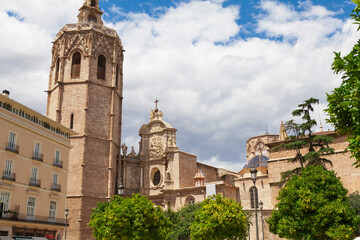 Fototapeta na wymiar Metropolitan Basilica Cathedral of Saint Mary in Valencia with the bell tower El Miquelete. Plaza de la Reina. Spain.