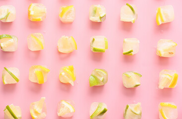 Ice with frozen citrus fruits on color background