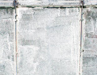 White grungy messy wall texture / background / pattern / wallpaper. Greenhouse / glasshouse glass wall segments painted in white 