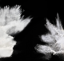 cloud of white wheat flour on a black background, particles fly in different directions