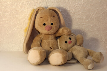 Family of bunnies on a white background. Plush rabbit toy.