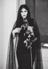 Woman in black long dress, gothic style, classical lady gothic, victorian style. Halloween dress