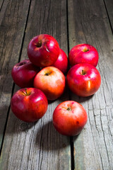 Red apples on wooden background. Copy space.