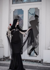Woman in black long dress, gothic style, classical lady gothic, victorian style. Halloween dress
