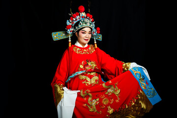 Asian Peking Opera opera actor wearing red costume in black background