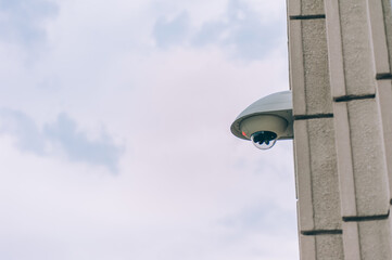 City web camera for surveillance on the background of the building and the sky.