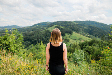 Young woman enjoying the view of a mountain range