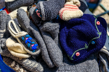 Hand knitted wool socks, slippers and hats at an outdoor farmer's market in old town Kotor, Montenegro