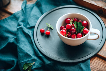 Ripe cherries in a mug. Good Morning Concept Cottagecore Aesthetics. Rustic, vintage style. Selective focus. Macro