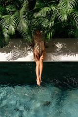 Young black woman relaxing at spa pool. Beautiful woman relaxing in outdoor spa swimming pool....