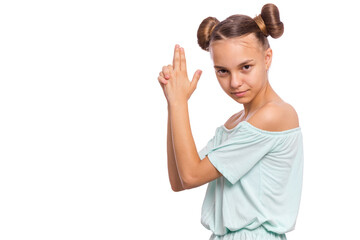 Portrait of funny teen girl doing gun gesture getting ready to shoot. Caucasian young teenager showing raised gun gesture isolated on white background. Child holding symbolic gun. Emotions and signs.