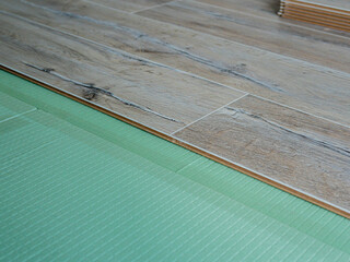 Laminate flooring.Flexible panel of quartz-vinyl flooring in the apartment are laid on the noise...