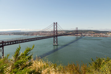 Bridge on April 25 in Lisbon on the Tejo river with moving cars.