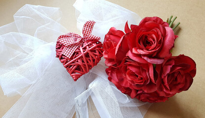 Red roses and red heart on tulle background