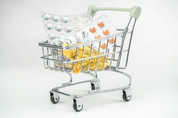 omega 3 fish oil big gel capsules, pills in a shopping cart, pharmacy, drugs selling concept, healthcare, vitamins