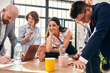 Business negotiation, male partners arguing, funny easygoing woman keeping calm in stressing situation, meditating with composed smile, dealing with emotional angry customer, stress management concept