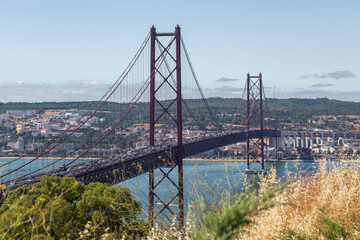 Bridge on April 25 in Lisbon on the Tejo river with moving cars.