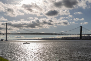 Bridge on April 25 in Lisbon on the Tejo river with moving cars.