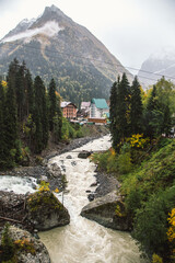 Dombay ski resort in autumn season, view on Amanaus river from the bridge in village, Caucasus, Russia