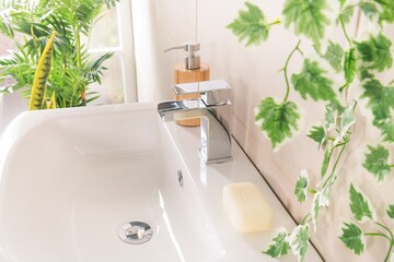 New and modern steel faucet with the ceramic sink in the bathroom