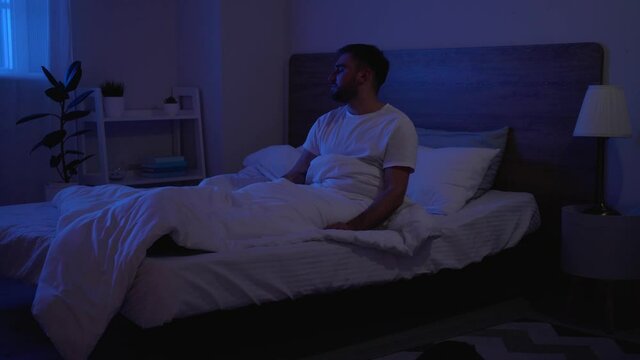 Male sleepwalker in bedroom at night