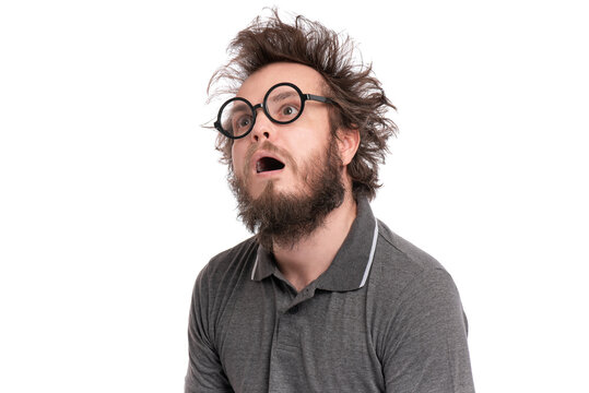 Crazy Scared or Shocked Bearded Man with funny Haircut in Eyeglasses looks Worried. Silly, Afraid or Surprised guy, isolated on white background.