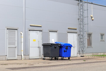Back side of the warehouse building with garbage cans