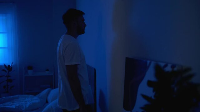 Male sleepwalker in bedroom at night