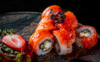 sushi roll with salmon, avocado, cream cheese in plate
