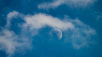 moon in the sky white clouds blue heavenly scenery