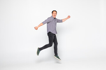 Fototapeta na wymiar Cheerful young man jumping isolated over a white background