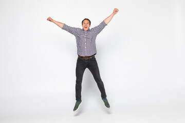 Cheerful young man jumping isolated over a white background