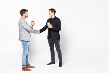 Two businessman handshake standing with coffee cup isolated on a white background