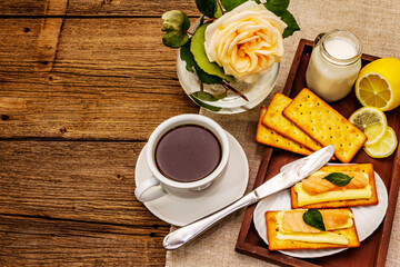 Healthy breakfast. Cup of coffee (black tea), milk, crackers with butter and salmon