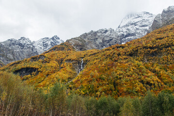 Beautiful colorful landscape in the mountains of Dombay ski resort in autumn season, trekking and hiking in the mountains.