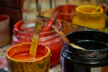 multicolored gouache paints in jars in close up