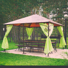 Empty gazebo or tent in a green Park. A place to relax in the Park