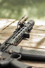 Military AR15 automatic assault rifle weapon with aim sight and flashlight
