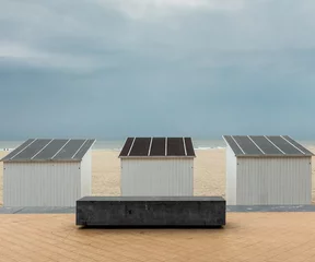 Foto op Plexiglas Three white beach huts against dark grey clouds. © Erik_AJV