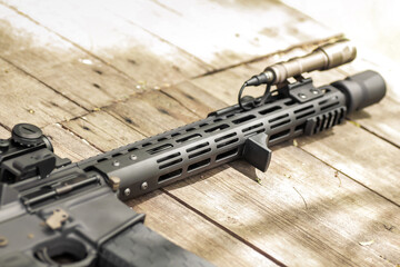 Military AR15 automatic assault rifle weapon with aim sight and flashlight
