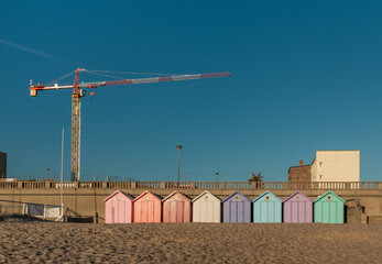 Stella Plage, France - 21 July 2020: Row of vintage beach cabins against blue sky.