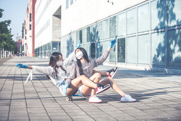 Two asian girls having fun outdoor after coronavirus lockdown