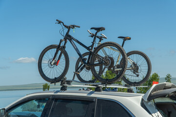 bicycles are attached to the trunk of the car. concept of active recreation.