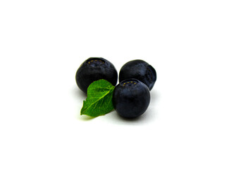 Three blueberries with a leaf
