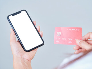 Woman with smartphone and credit card