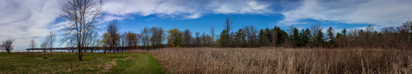 Fototapeta premium Colour panorama landscape photograph taken at Lemoine Point Conservation Area on a clear summer day in Kingston, Ontario Canada.